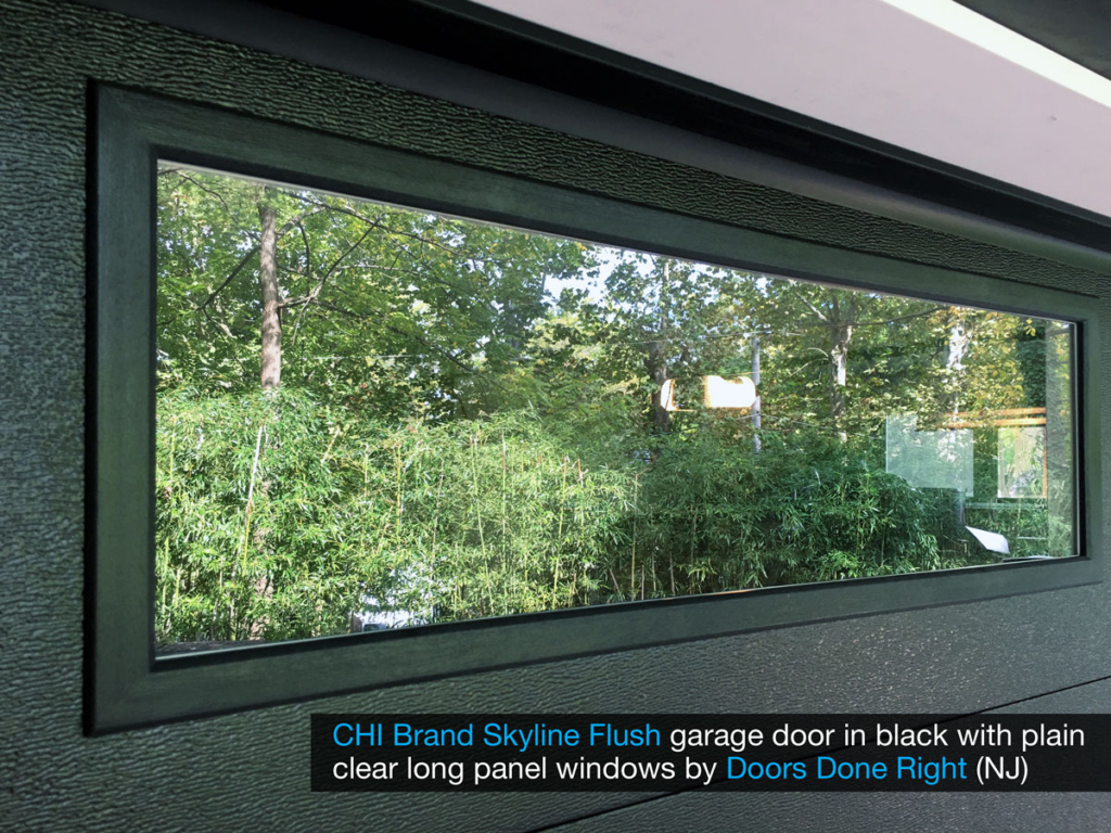 chi model 2284 skyline flush garage door in black with clear long panel windows in top door section - window closeup