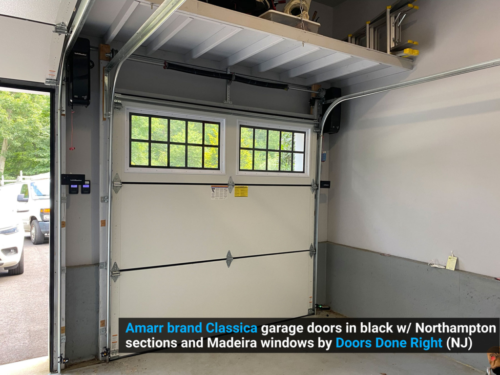 Amarr brand Classica garage doors in black w/ Northampton sections and Madeira windows inside single door